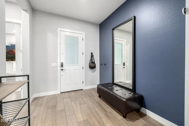 a view of a dining room with furniture a chandelier and wooden floor