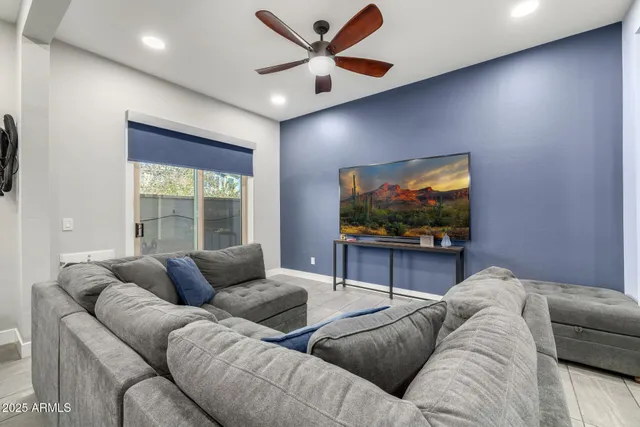 a living room with furniture plant and a large window