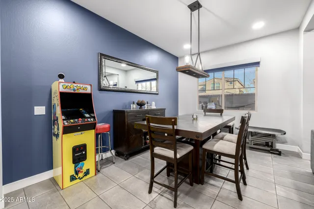 a dining room with furniture a chandelier and wooden floor