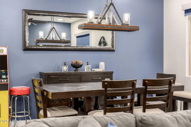 a kitchen with stainless steel appliances granite countertop a sink a stove a refrigerator and white cabinets with wooden floor