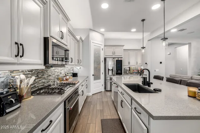 a spacious bathroom with a granite countertop sink mirror and shower