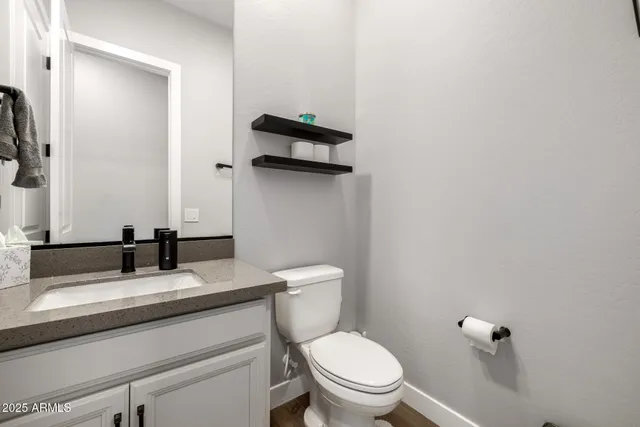 a bathroom with double sink and a mirror