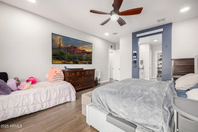 a living room with furniture a flat screen tv and kitchen view