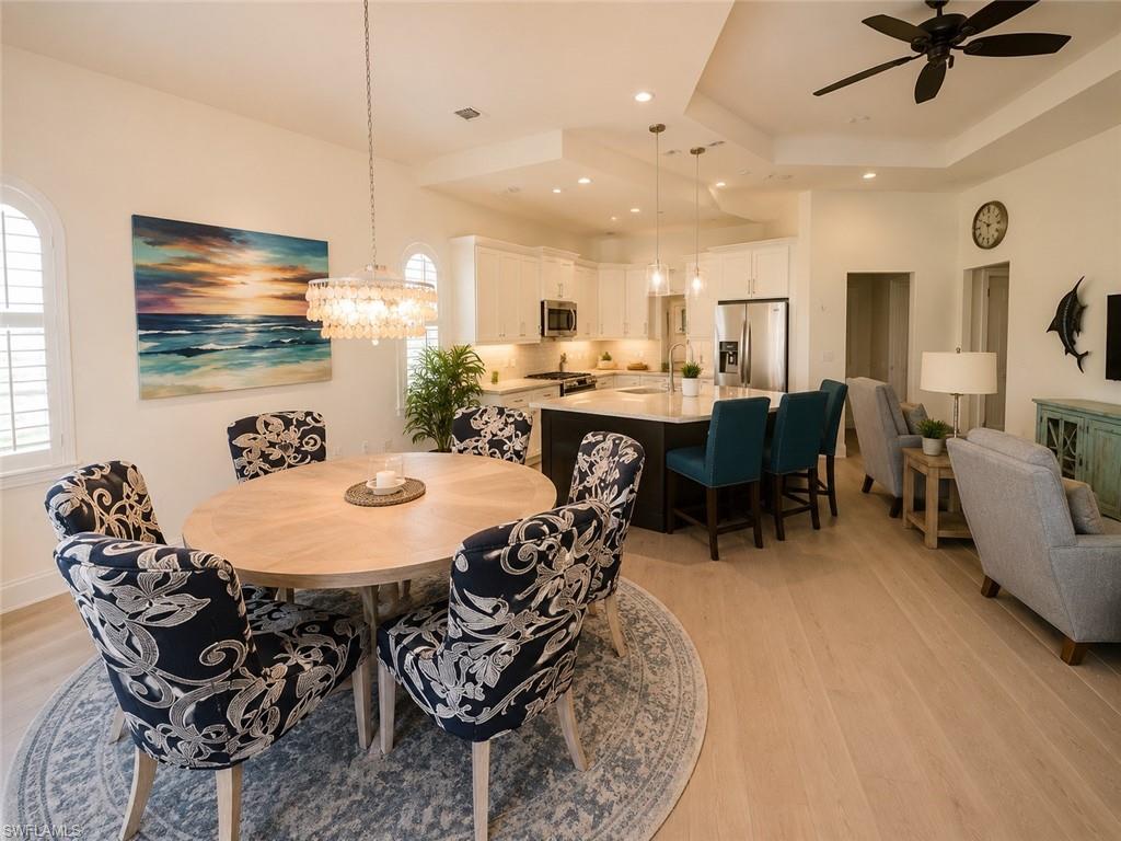 6574 Amarone Lane Naples, FL 34113 - Photo 7 of 44 a view of a dining room with furniture