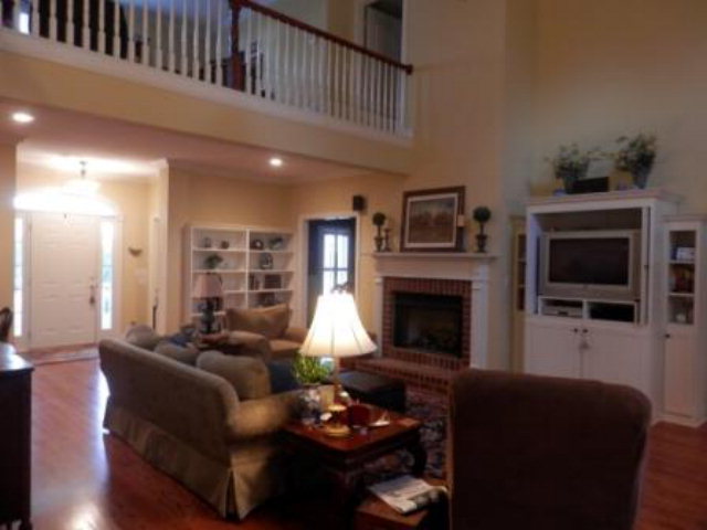 700 Jenkins Road Forsyth, GA 31029 - Photo 3 of 11 a living room with furniture and a fireplace