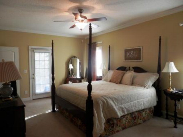 700 Jenkins Road Forsyth, GA 31029 - Photo 7 of 11 a bedroom with bed and a chandelier