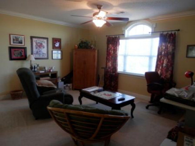 700 Jenkins Road Forsyth, GA 31029 - Photo 9 of 11 a living room with furniture a chandelier and a window