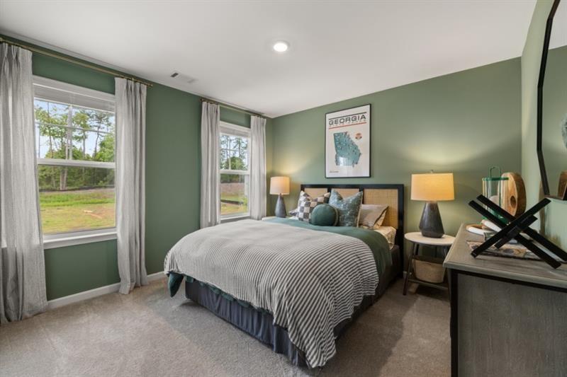 422 Red Dragon Drive Jefferson, GA 30549 - Photo 17 of 20 a spacious bedroom with a bed and a window