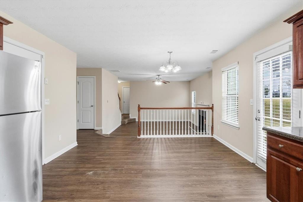 2827 Riders Court Northeast Dacula, GA 30019 - Photo 15 of 41 a view of a hallway with wooden floor and a kitchen