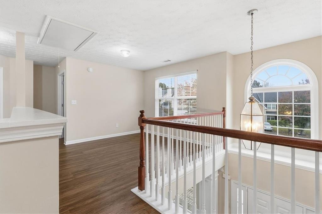 2827 Riders Court Northeast Dacula, GA 30019 - Photo 18 of 41 a view of a room with wooden floor and windows