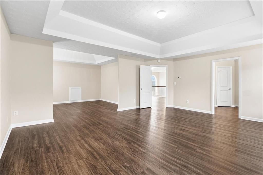2827 Riders Court Northeast Dacula, GA 30019 - Photo 21 of 41 a view of an empty room with wooden floor and windows