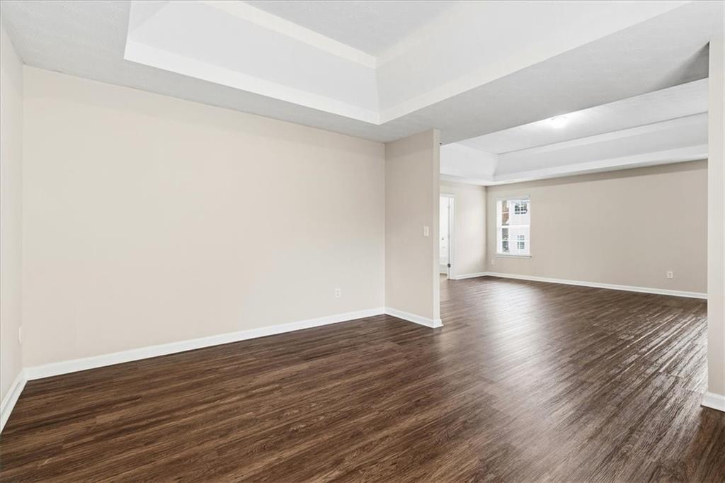 2827 Riders Court Northeast Dacula, GA 30019 - Photo 23 of 41 a view of an empty room with wooden floor and windows