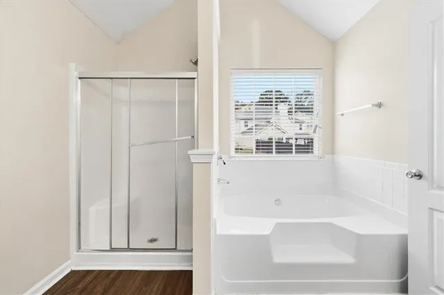 a bathroom with a bathtub and a shower