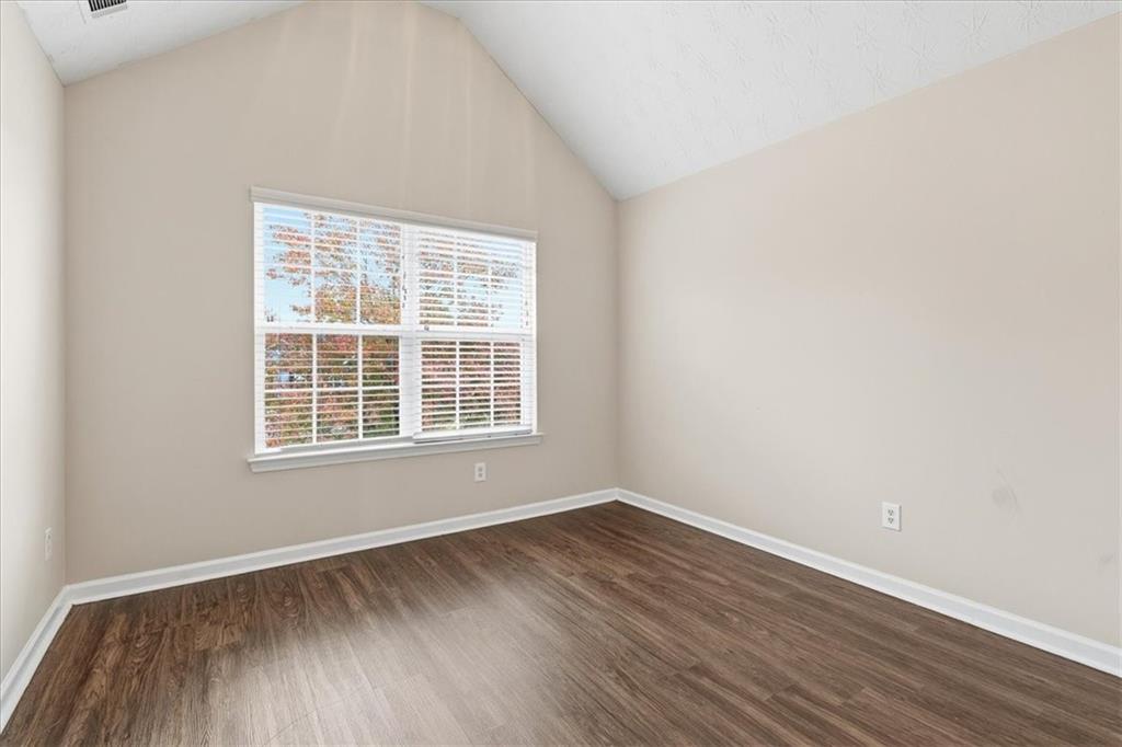2827 Riders Court Northeast Dacula, GA 30019 - Photo 28 of 41 an empty room with wooden floor and windows