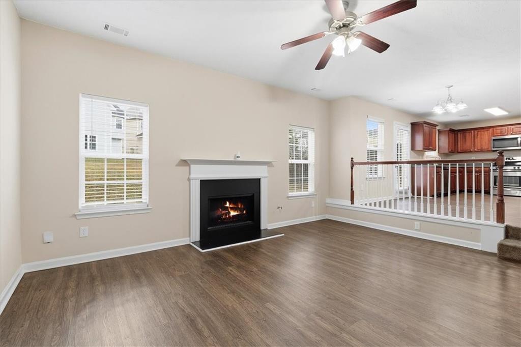2827 Riders Court Northeast Dacula, GA 30019 - Photo 10 of 41 a view of empty room with wooden floor and fan