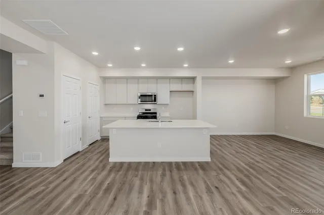 a view of kitchen with sink and wooden floor