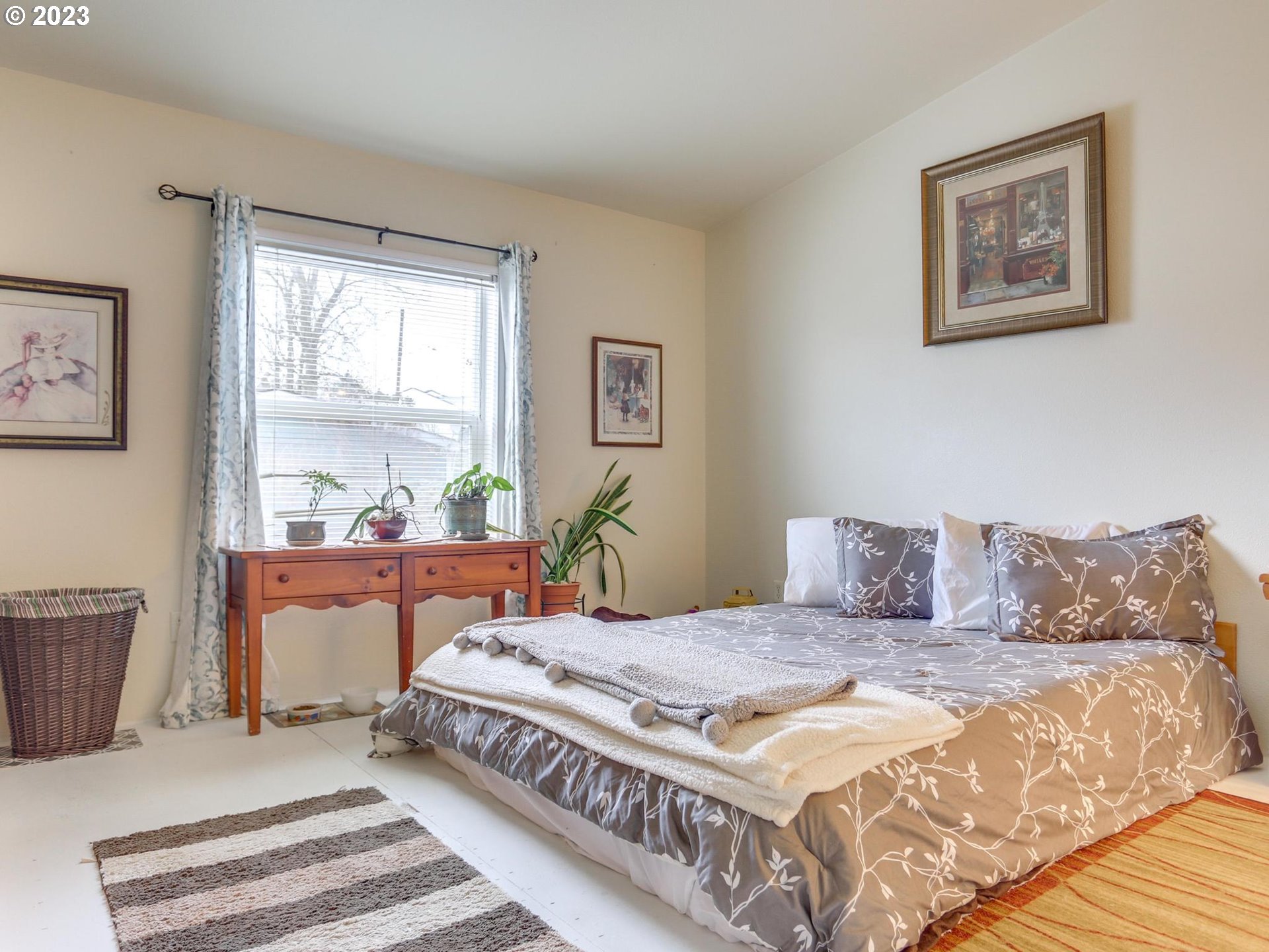 1819 Southeast Orient Drive, Unit 1 Gresham, OR 97080 - Photo 14 of 30 a bedroom with a bed a table and a window