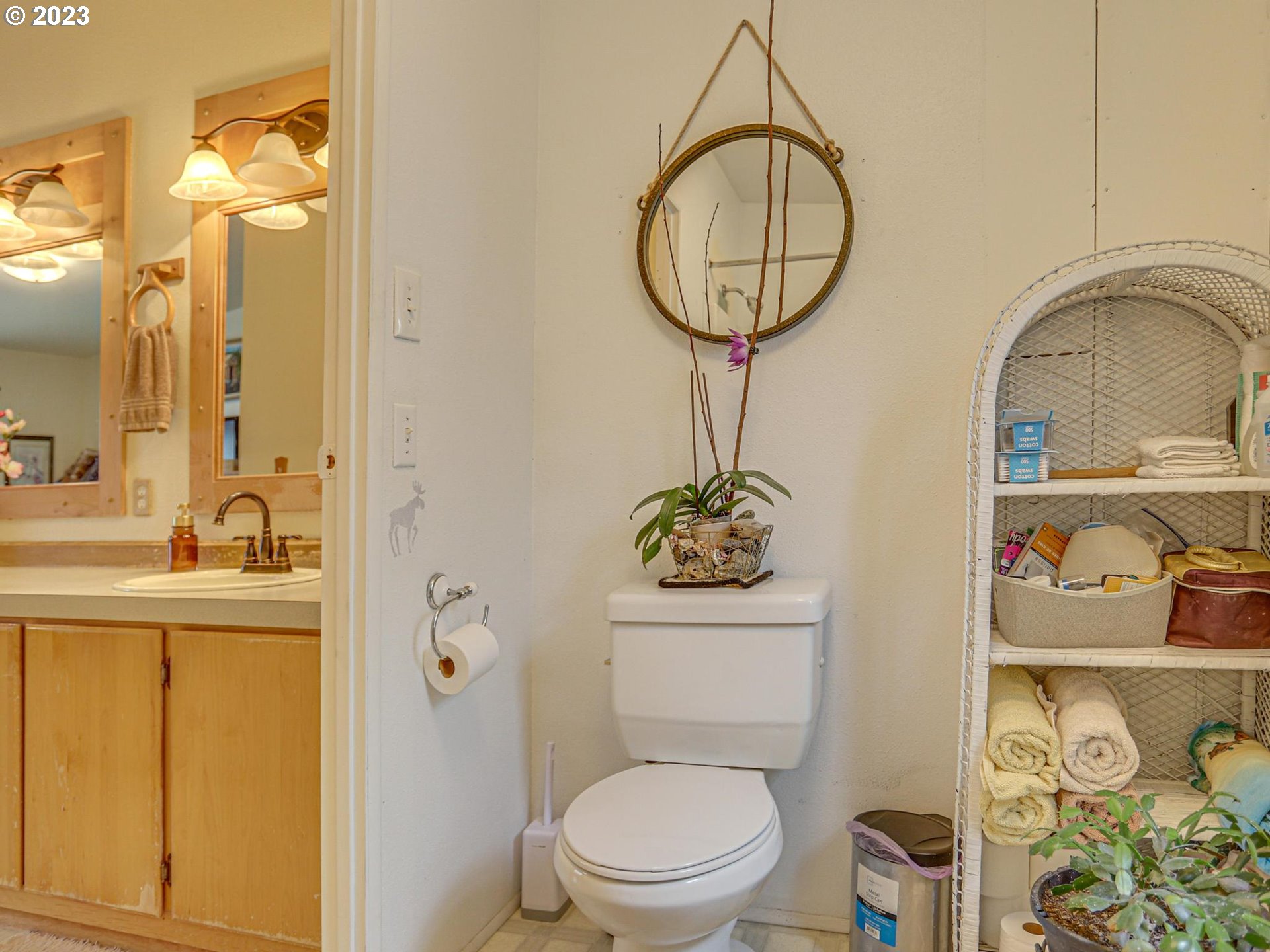 1819 Southeast Orient Drive, Unit 1 Gresham, OR 97080 - Photo 17 of 30 a bathroom with a toilet a sink and a mirror