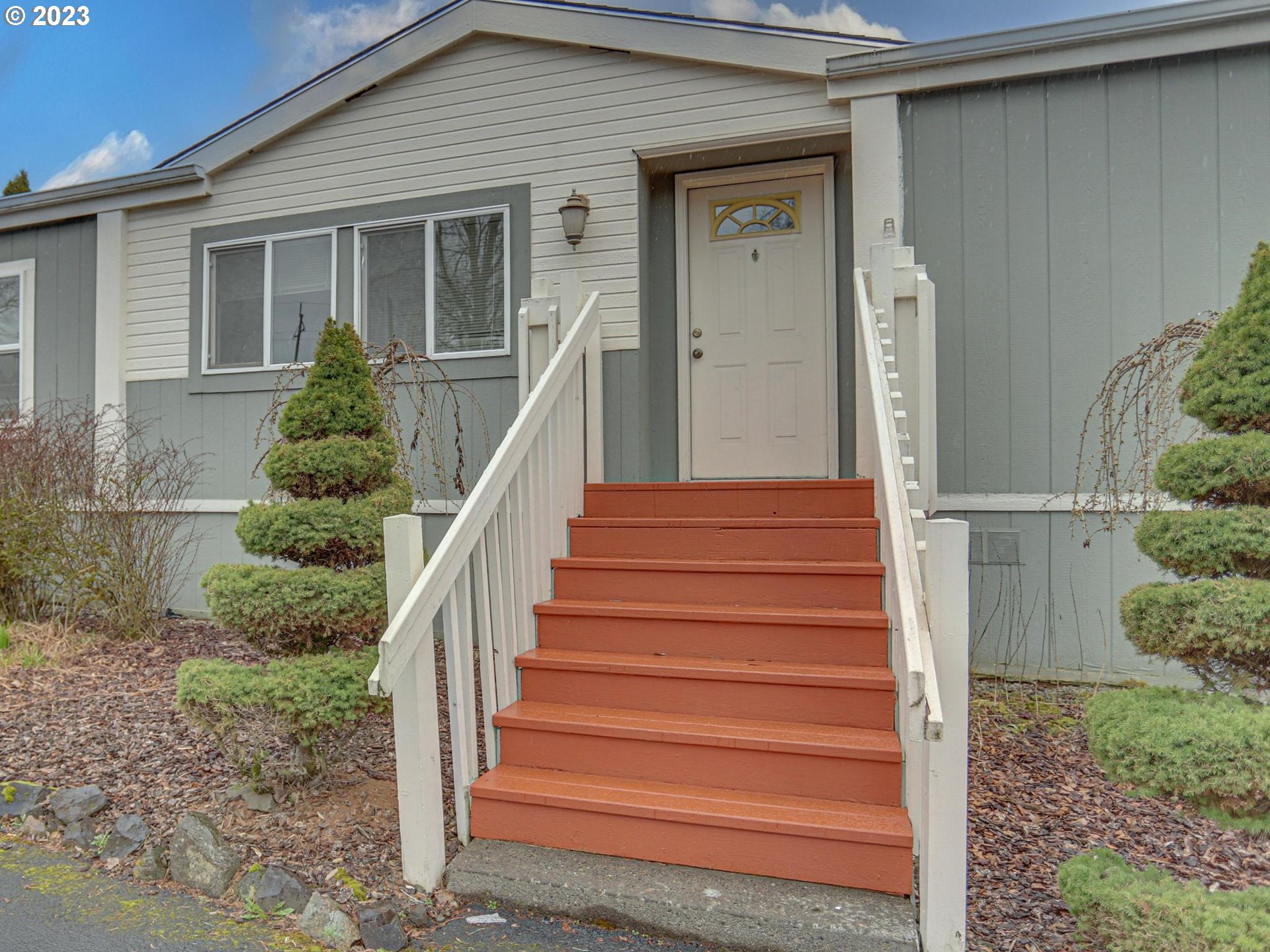 1819 Southeast Orient Drive, Unit 1 Gresham, OR 97080 - Photo 2 of 30 a view of a house with wooden fence and large windows