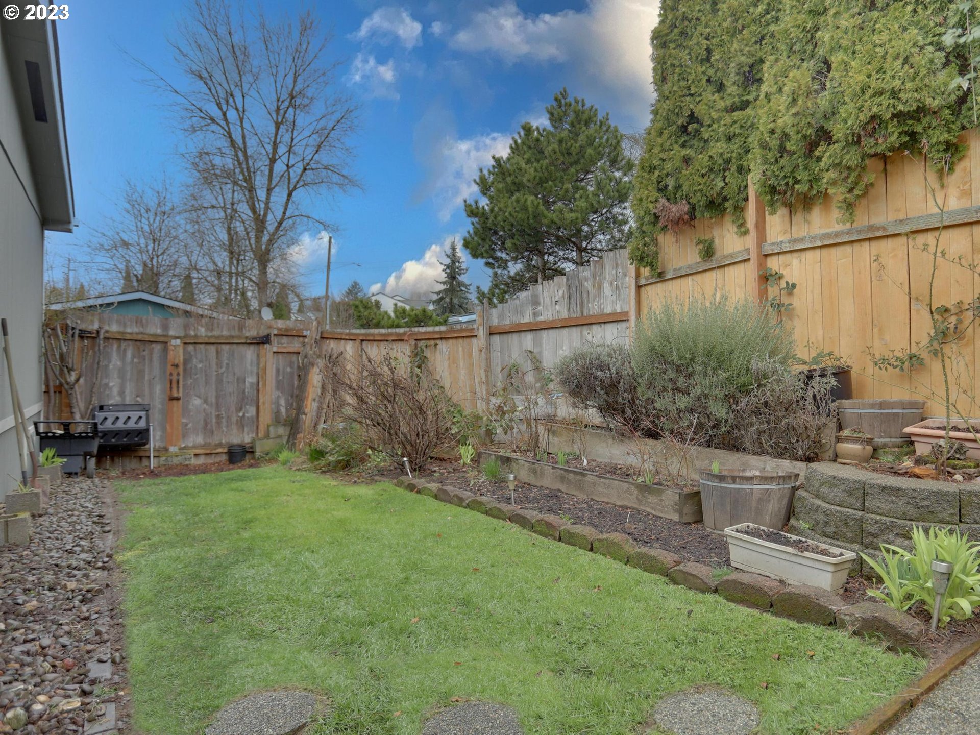1819 Southeast Orient Drive, Unit 1 Gresham, OR 97080 - Photo 27 of 30 a view of a backyard with table and chairs and wooden fence