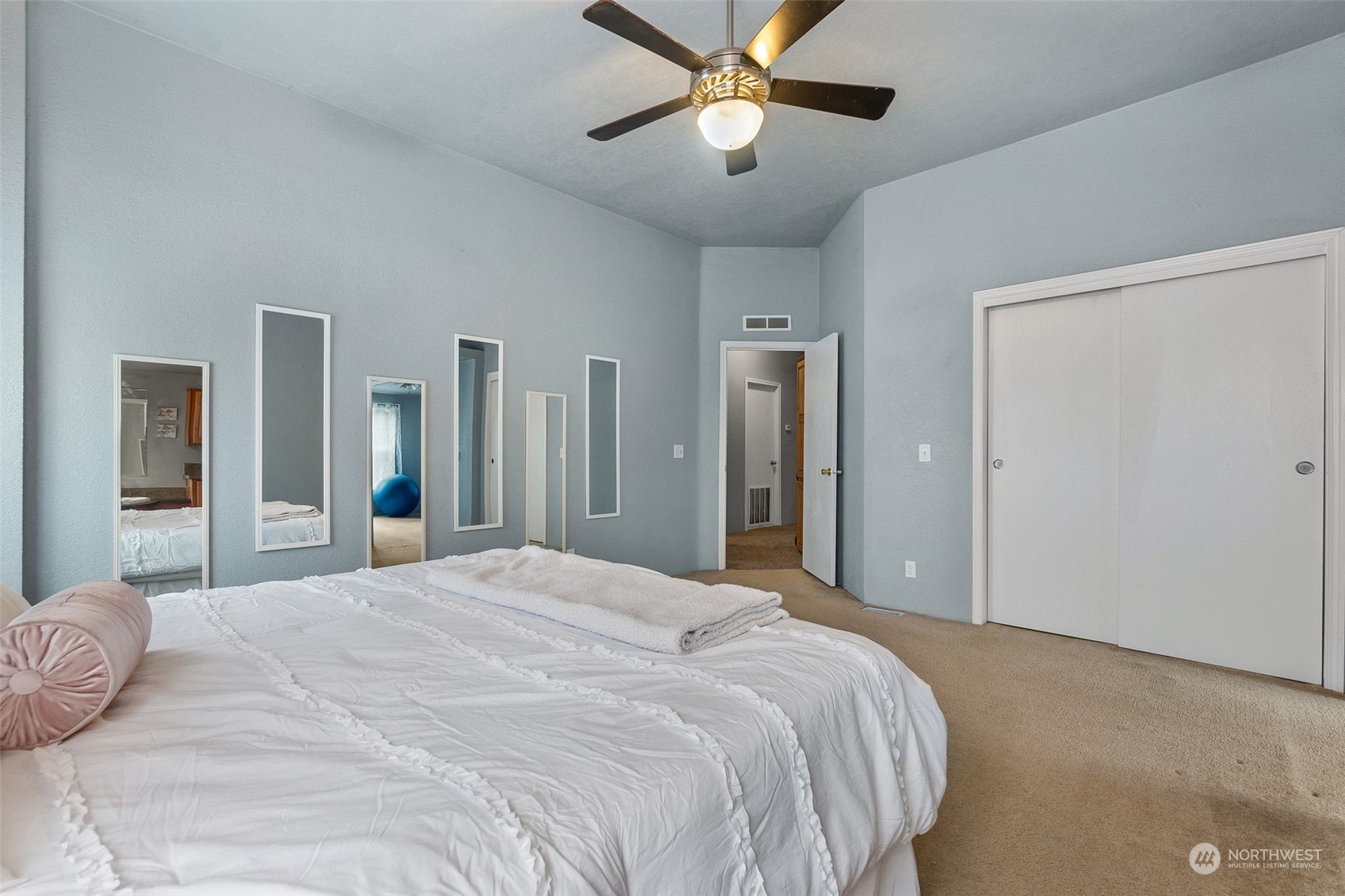 21632 Oregon Trail Road Southwest Centralia, WA 98531 - Photo 19 of 33 a bedroom with a large bed and a chandelier