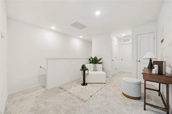 a living room with furniture and white walls