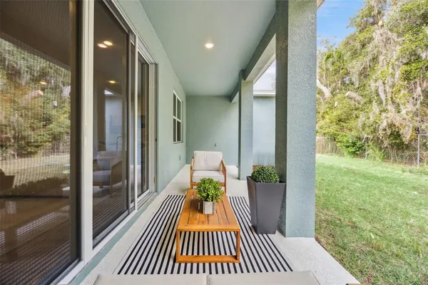 a living room with furniture and a floor to ceiling window