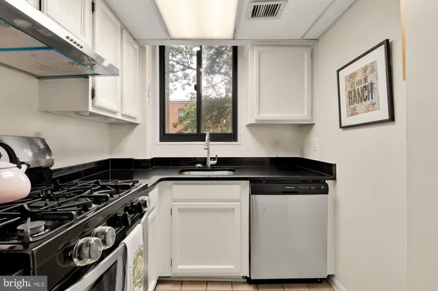 a stove top oven sitting inside of a kitchen