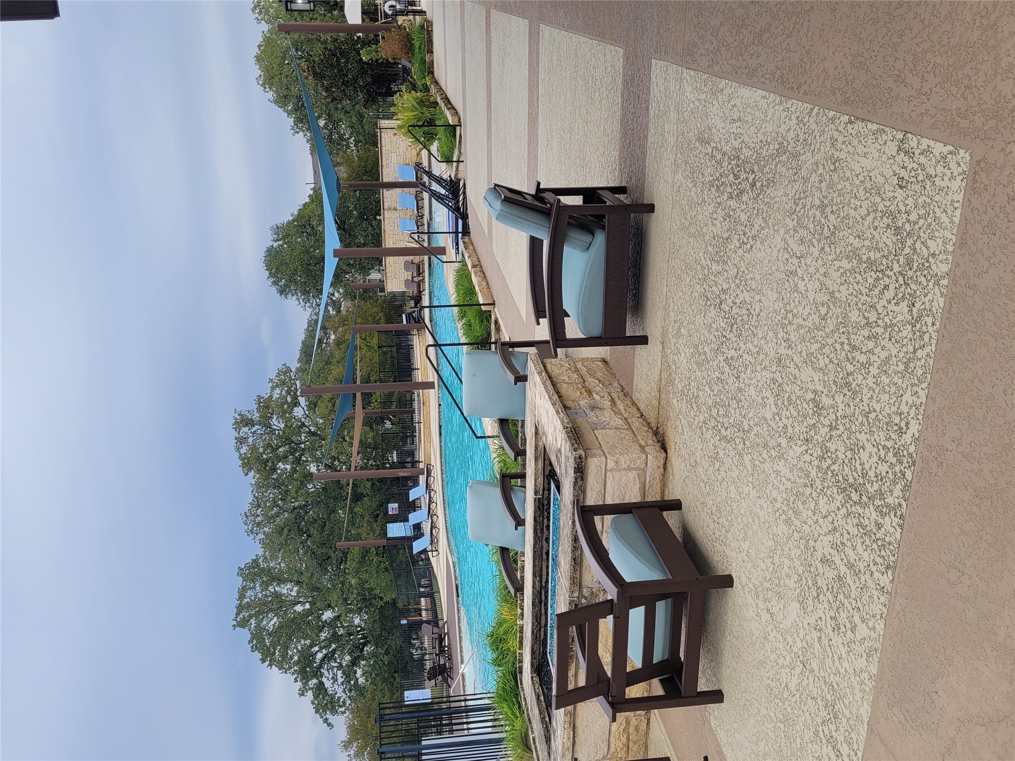 120 Free Stone Drive Georgetown, TX 78628 - Photo 32 of 40 An inviting outdoor seating area with a fire pit beside a refreshing pool, perfect for relaxation.