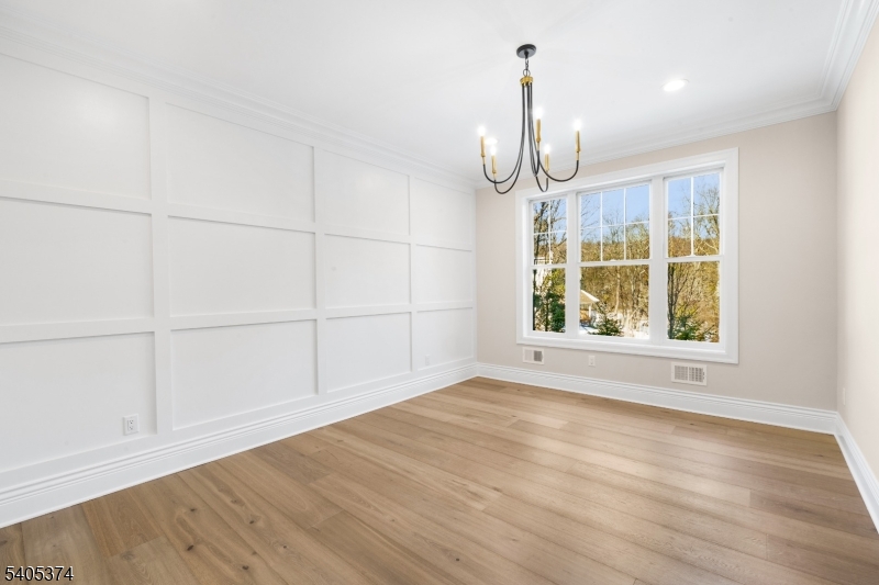 502 Tiffany Way Watchung, NJ 07069 - Photo 12 of 41 an empty room with wooden floor cabinet and windows