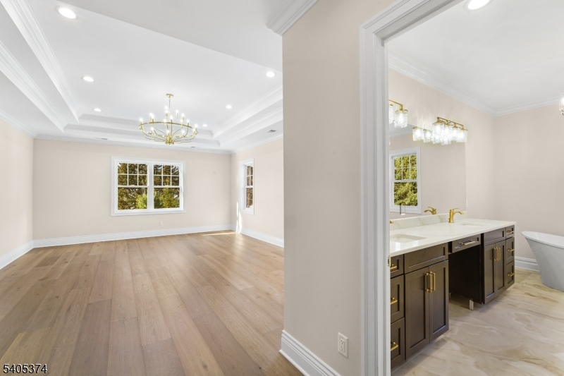 502 Tiffany Way Watchung, NJ 07069 - Photo 20 of 41 a spacious bathroom with a granite countertop sink a large mirror and a vanity