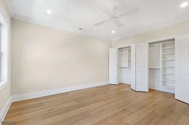 a view of empty room with wooden floor and entryway