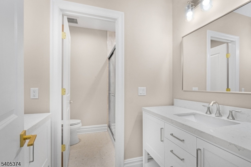 502 Tiffany Way Watchung, NJ 07069 - Photo 29 of 41 a bathroom with a granite countertop sink toilet and shower
