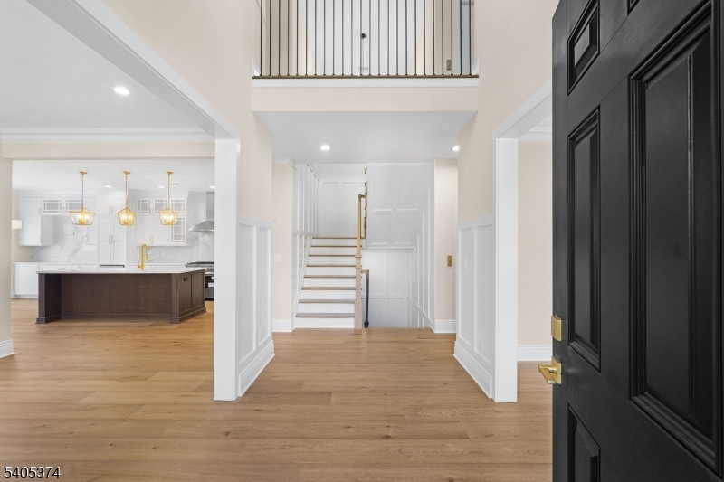 502 Tiffany Way Watchung, NJ 07069 - Photo 36 of 41 a view of a hallway with wooden floor and staircase