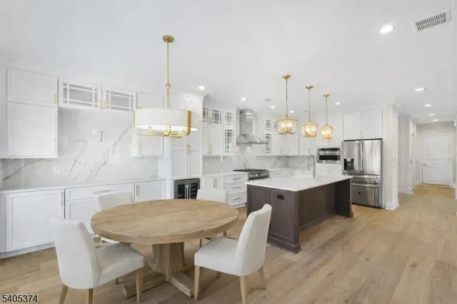 a kitchen with stainless steel appliances kitchen island granite countertop a sink and cabinets