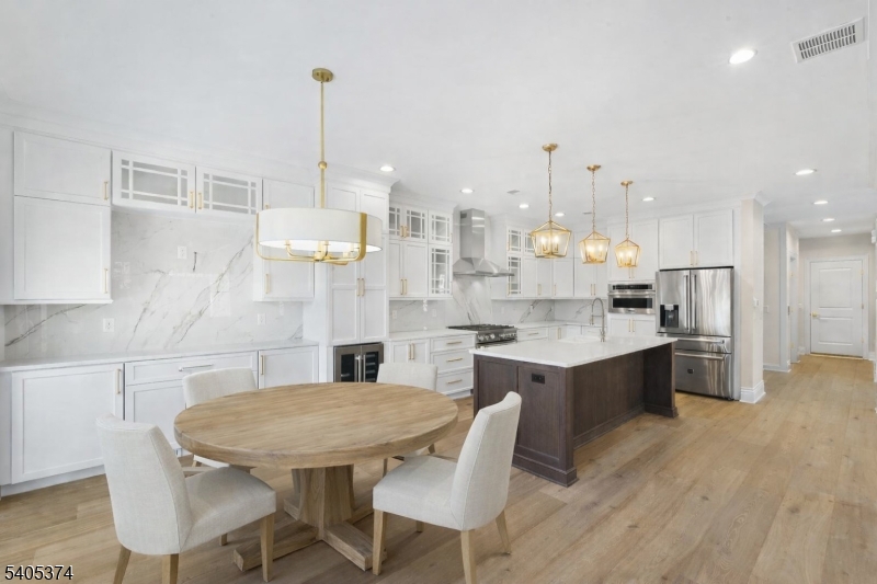 502 Tiffany Way Watchung, NJ 07069 - Photo 4 of 41 a kitchen with stainless steel appliances kitchen island granite countertop a sink and cabinets