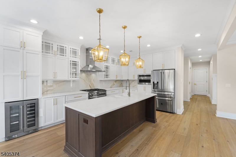 502 Tiffany Way Watchung, NJ 07069 - Photo 6 of 41 a large kitchen with stainless steel appliances kitchen island granite countertop a sink a stove and a wooden floors