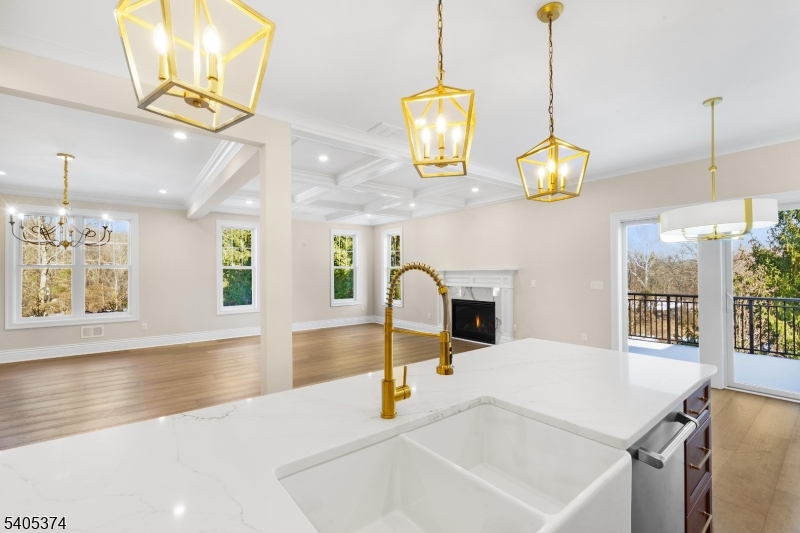 502 Tiffany Way Watchung, NJ 07069 - Photo 8 of 41 a kitchen with stainless steel appliances kitchen island granite countertop a sink a counter top space and living room view
