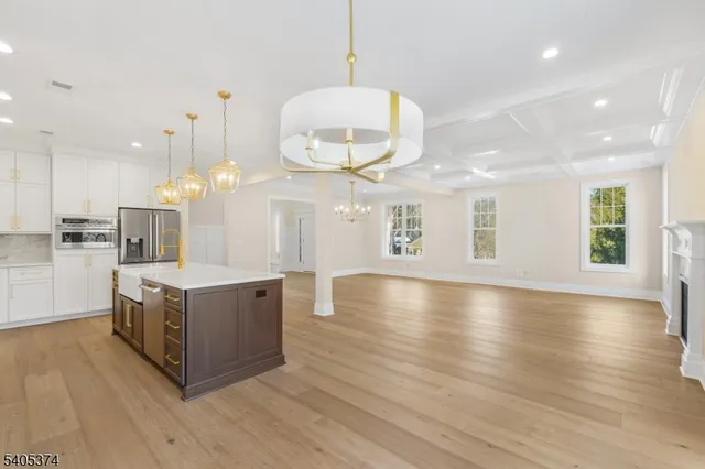 a kitchen with stainless steel appliances granite countertop a stove and a wooden floors