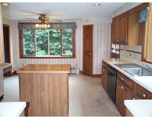 44 Concord Road Billerica, MA 01821 - Photo 3 of 12 a bathroom with a double vanity sink a large mirror and a bathtub