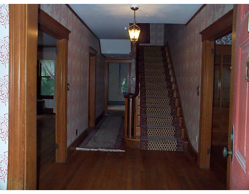 44 Concord Road Billerica, MA 01821 - Photo 8 of 12 a view of a hallway with wooden floor and stairs