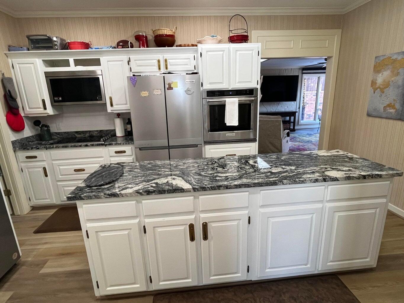 8 Westridge Square Plainview, TX 79072 - Photo 19 of 41 a kitchen with granite countertop a sink stove and microwave