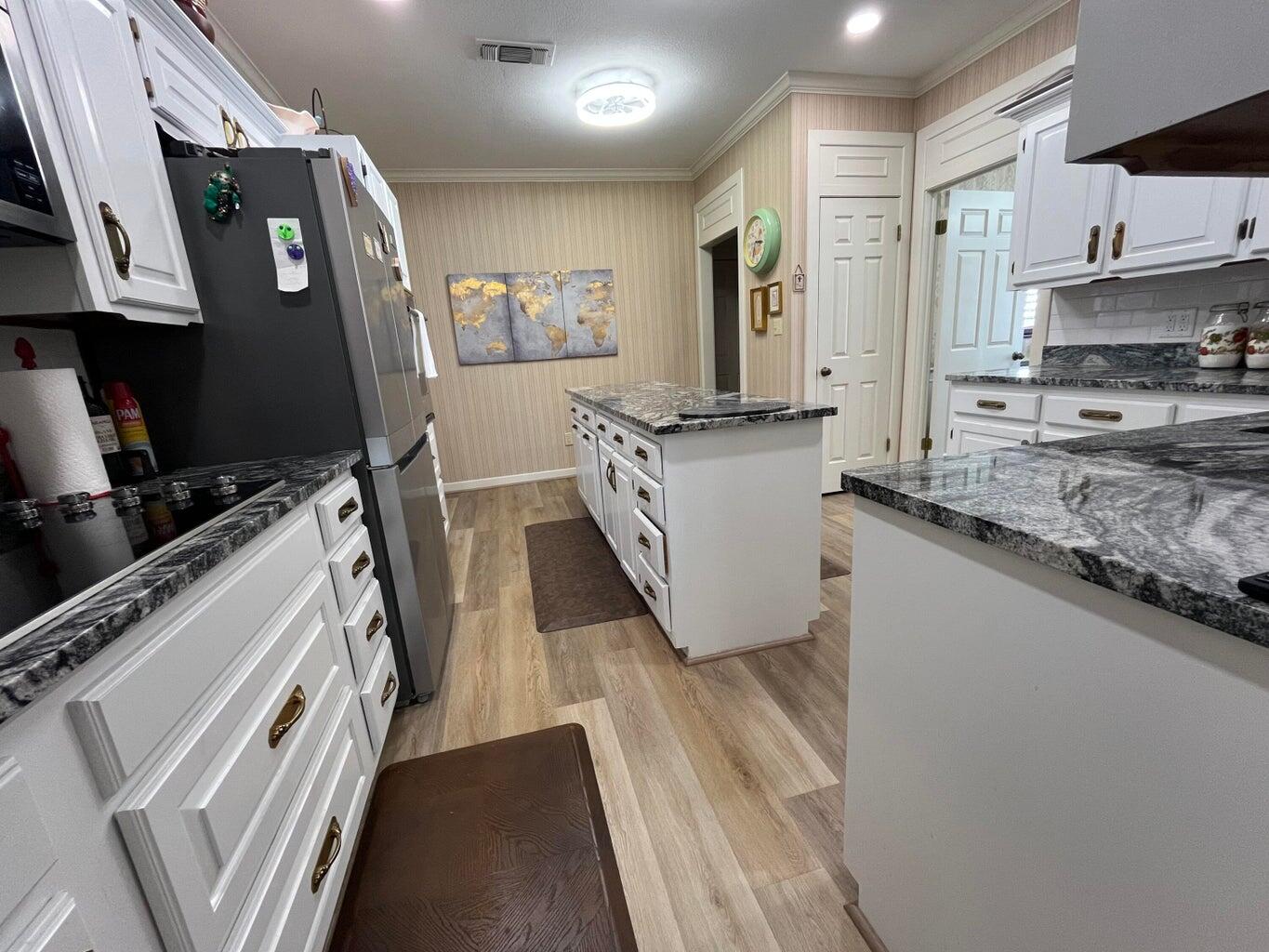 8 Westridge Square Plainview, TX 79072 - Photo 22 of 41 a kitchen with stainless steel appliances granite countertop a sink stove and refrigerator