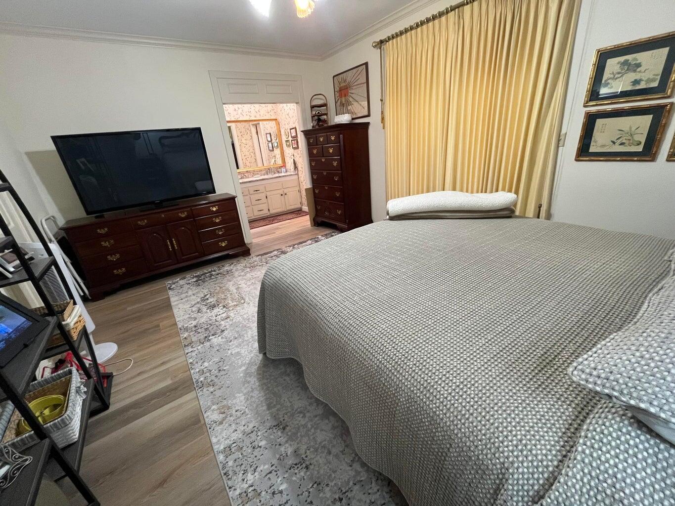 8 Westridge Square Plainview, TX 79072 - Photo 28 of 41 a bedroom with a bed and wooden floor