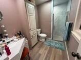 8 Westridge Square Plainview, TX 79072 - Photo 32 of 41 a bathroom with a sink and mirror with toilet