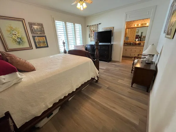 a bedroom with a bed a couch and dresser
