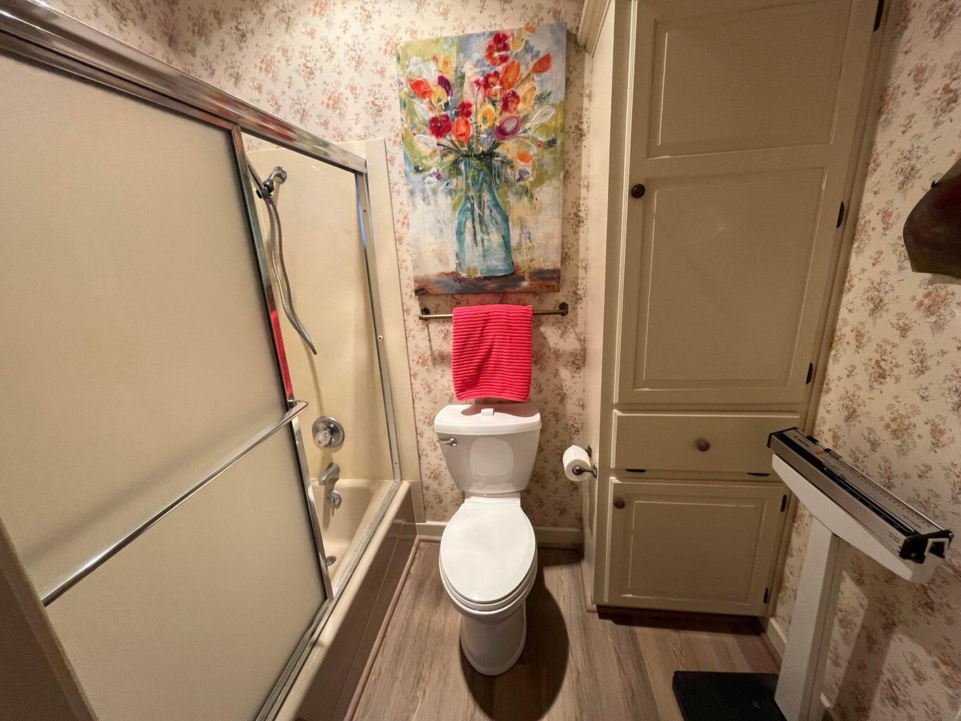 8 Westridge Square Plainview, TX 79072 - Photo 36 of 41 a bathroom with a toilet and a shower curtain