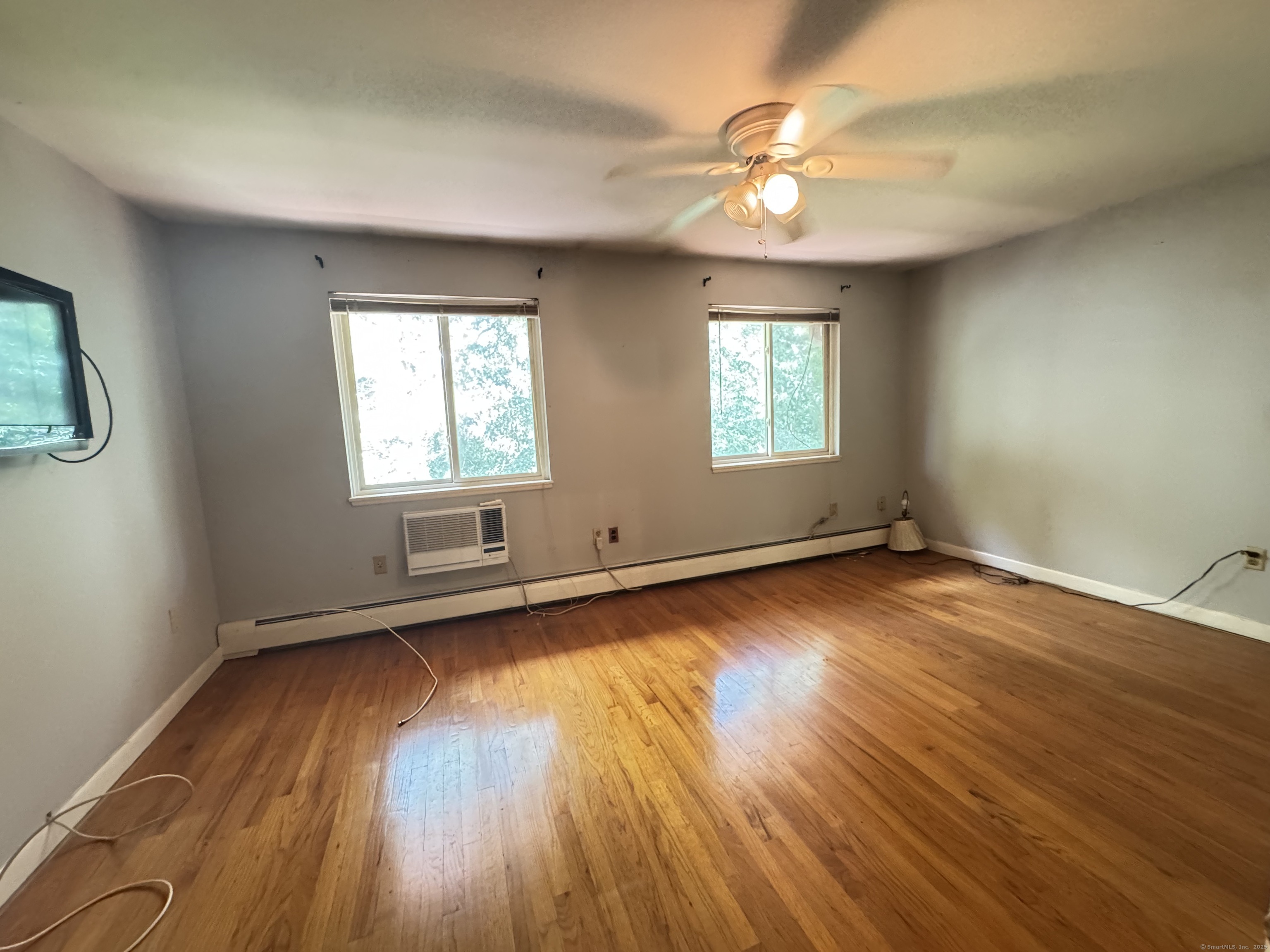 141 Worth Avenue Hamden, CT 06518 - Photo 12 of 17 an empty room with wooden floor and windows