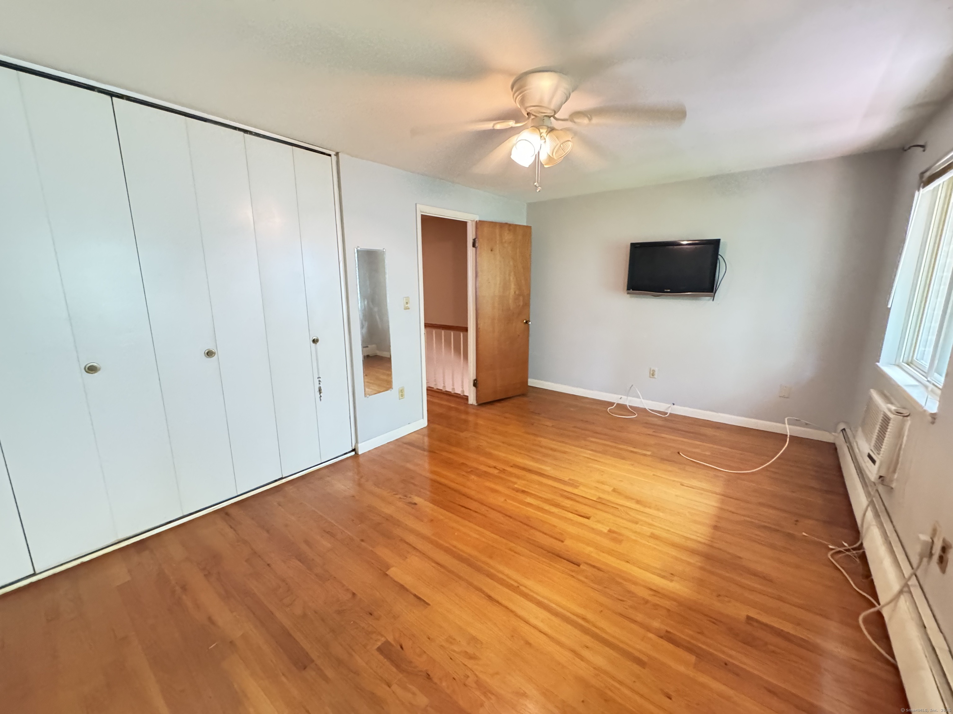 141 Worth Avenue Hamden, CT 06518 - Photo 13 of 17 a view of an empty room with window and wooden floor
