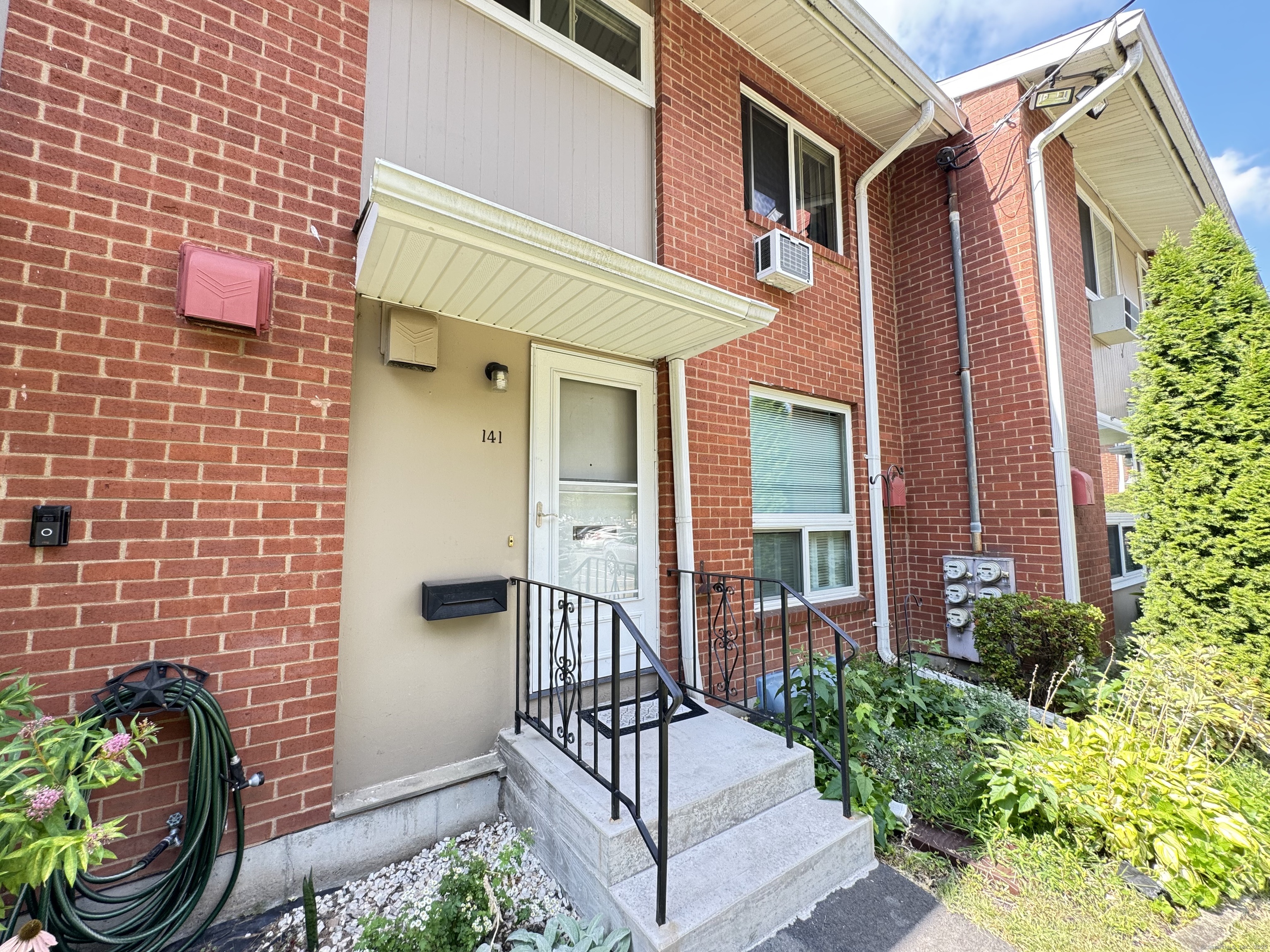 141 Worth Avenue Hamden, CT 06518 - Photo 2 of 17 a view of a house with a small yard and potted plants